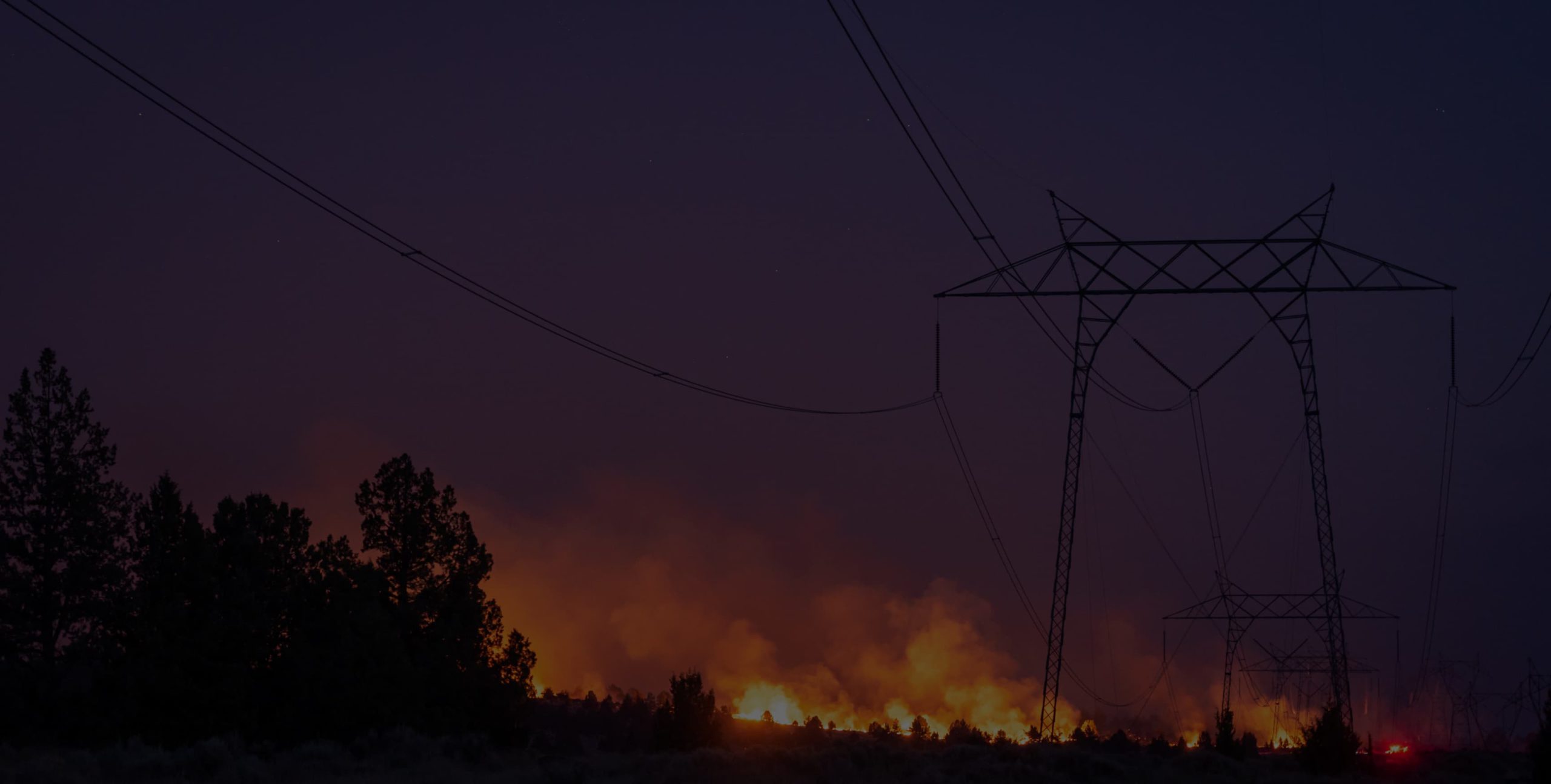 Power lines with a wildfire under them