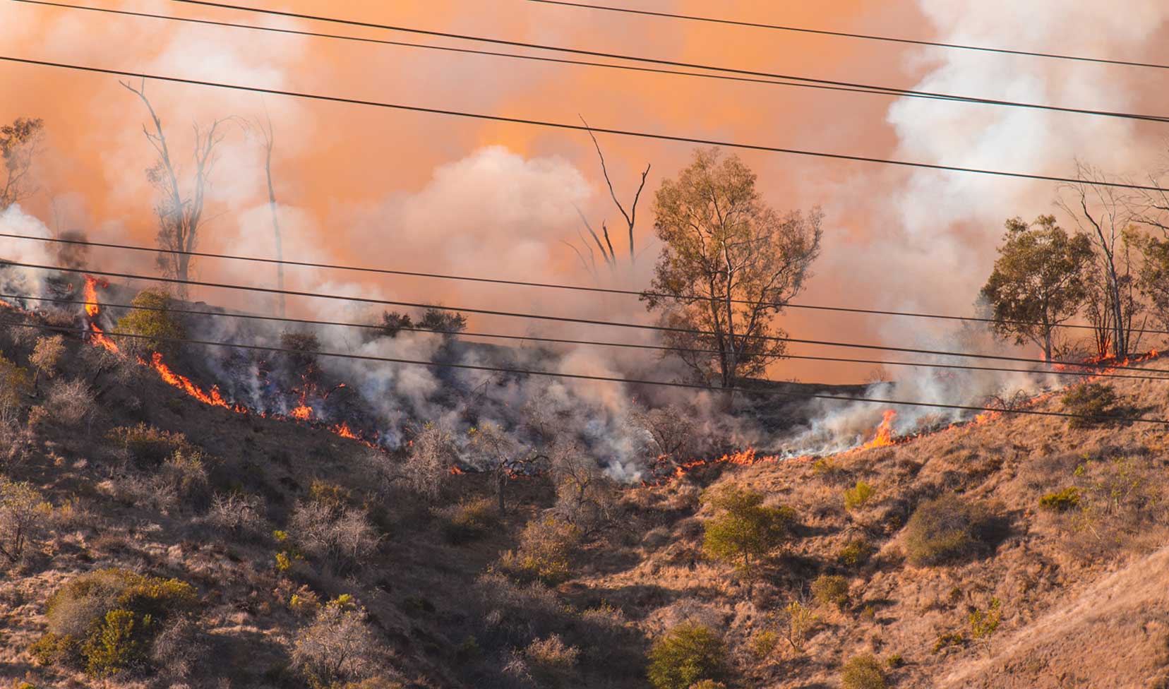 Fire on a ridge, near power lines