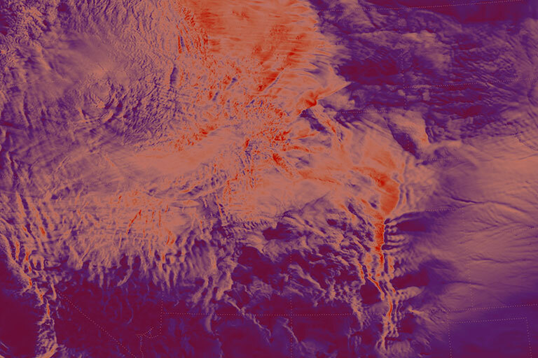 False-color topographic image of a mountainous landscape, with layered ridges and a prominent vertical valley on the right. Bright orange tones mark higher elevations, contrasting with darker purple lowlands.