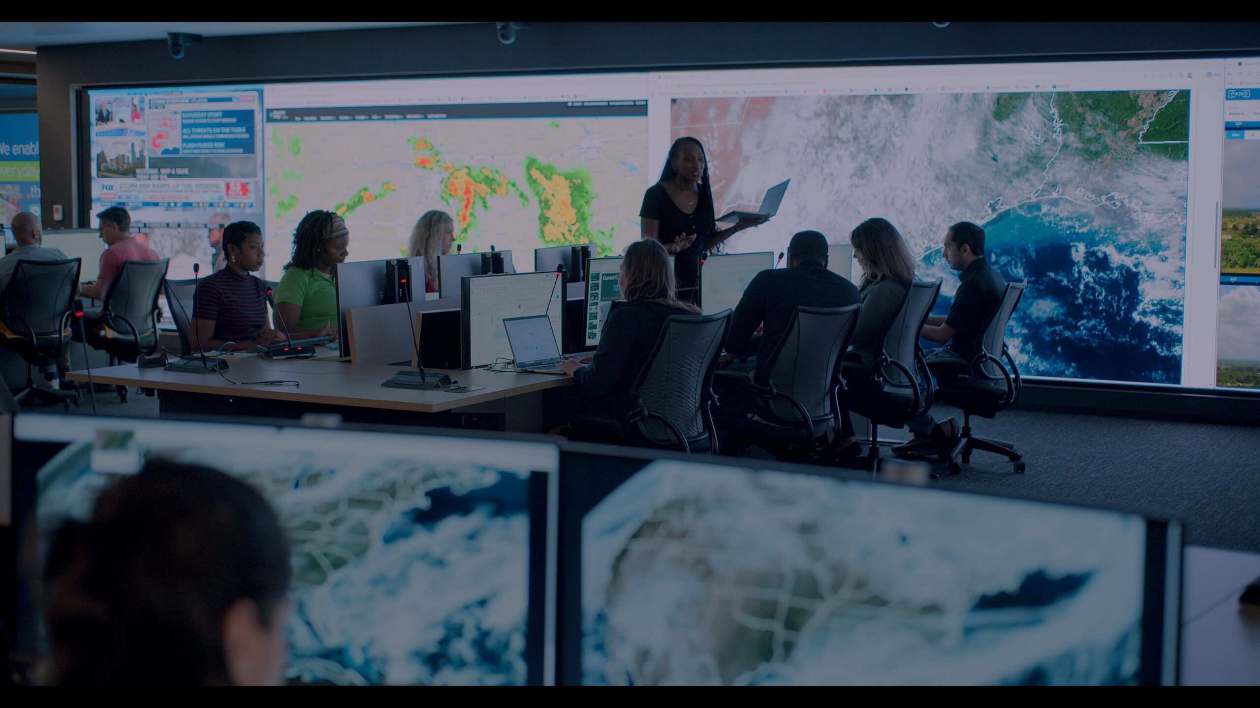 Utility and fire agency analysts using Technosylva wildfire and extreme weather risk intelligence platform in an emergency operations center